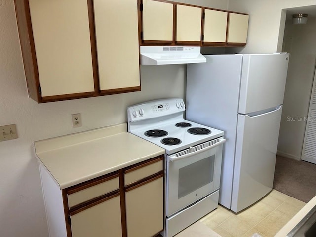 kitchen with white appliances, range hood, light countertops, and light colored carpet