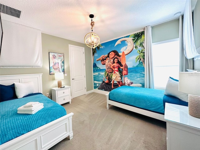 bedroom featuring an inviting chandelier, visible vents, a textured ceiling, and light colored carpet