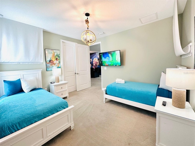 bedroom featuring an inviting chandelier and light colored carpet