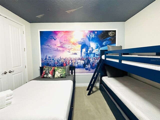 bedroom featuring carpet and a textured ceiling