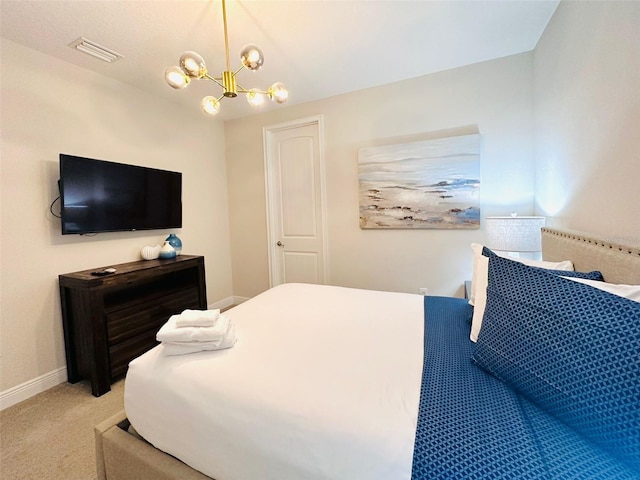 carpeted bedroom with a chandelier, visible vents, and baseboards