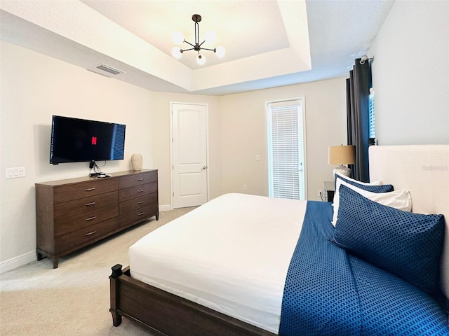 bedroom featuring light carpet, baseboards, visible vents, and a raised ceiling