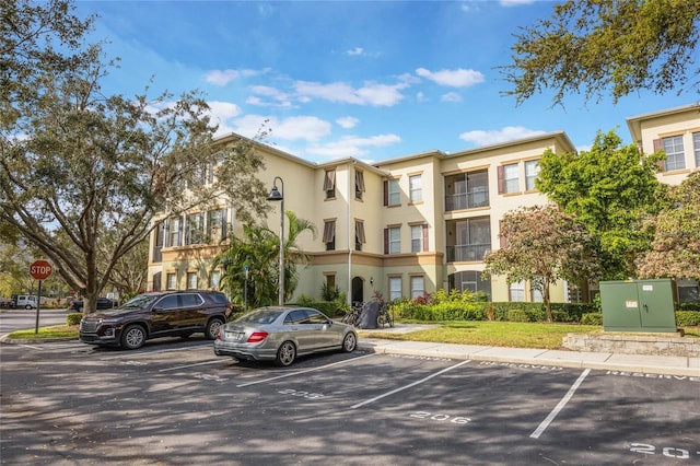 view of property featuring uncovered parking