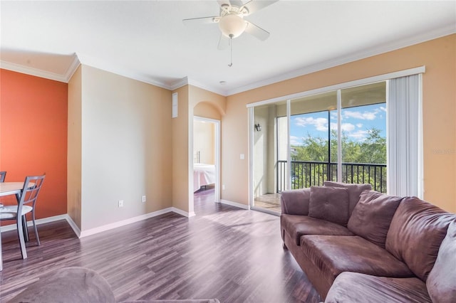 living room with ceiling fan, ornamental molding, wood finished floors, and baseboards