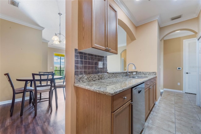 kitchen featuring crown molding, visible vents, decorative backsplash, a sink, and dishwasher