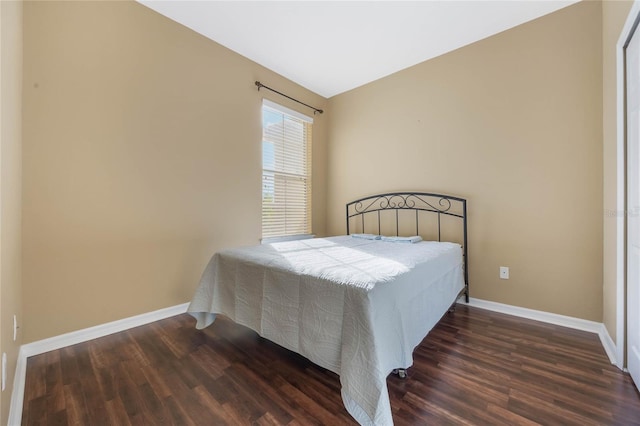 bedroom featuring dark wood finished floors and baseboards