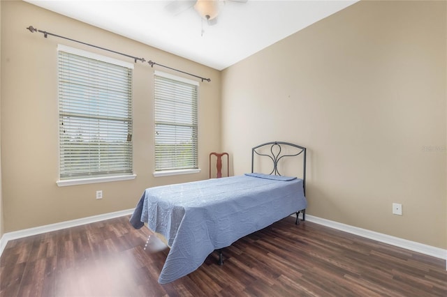 bedroom featuring wood finished floors, a ceiling fan, and baseboards