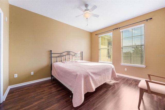 bedroom featuring a ceiling fan, baseboards, and wood finished floors