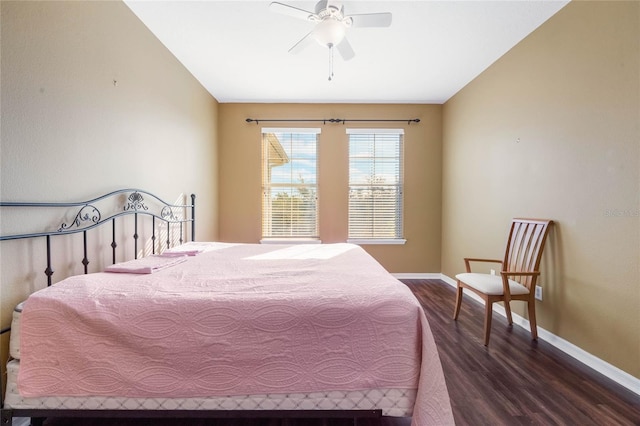 bedroom with dark wood-style flooring, vaulted ceiling, baseboards, and ceiling fan