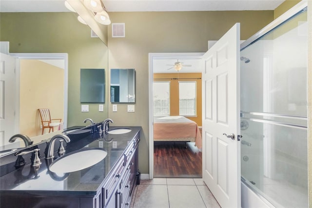 ensuite bathroom with visible vents, a sink, and tile patterned floors