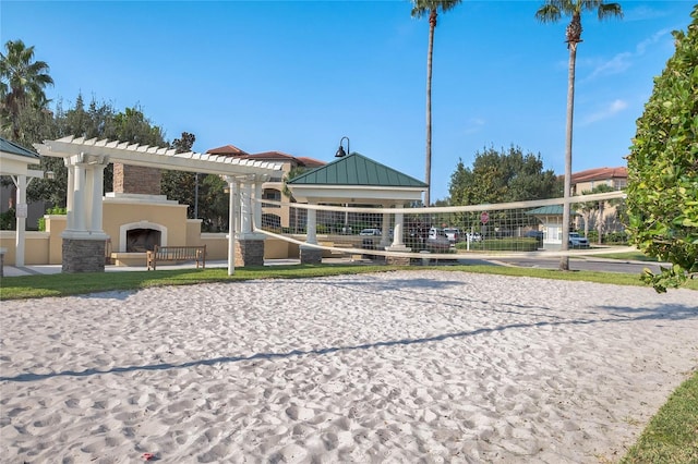 view of property's community featuring a pergola and volleyball court