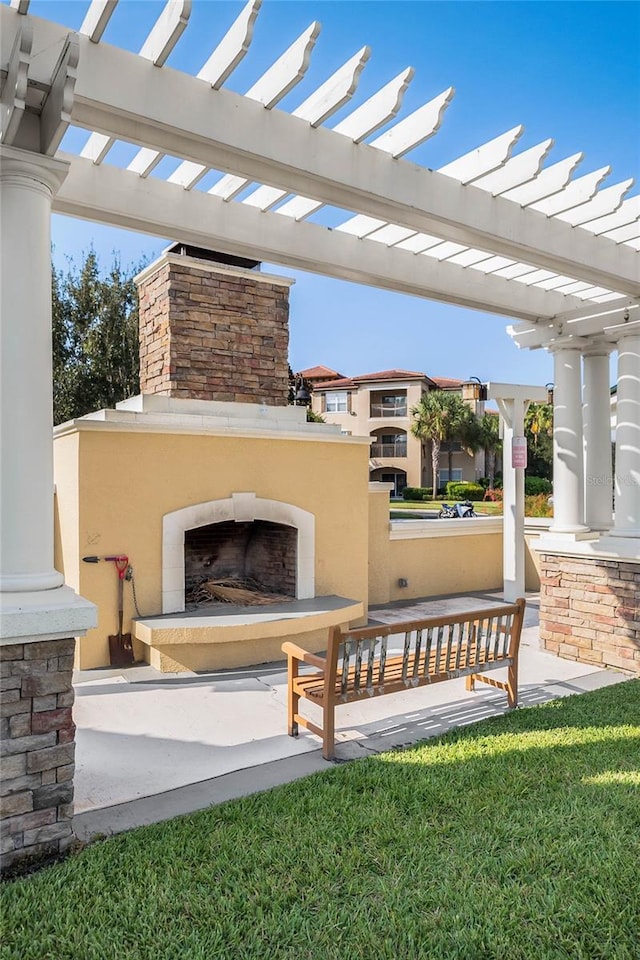 view of patio featuring a pergola and exterior fireplace