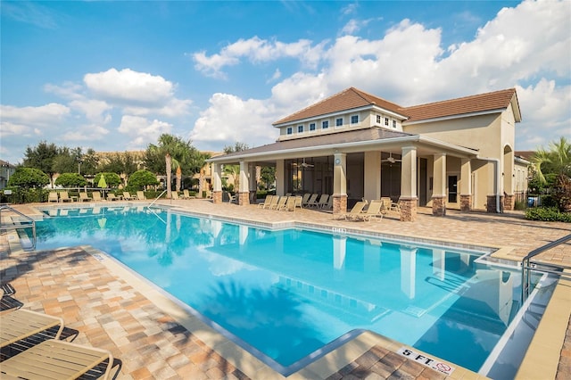 pool featuring a ceiling fan and a patio
