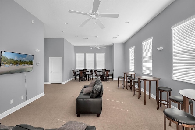 carpeted living area featuring ceiling fan, baseboards, and visible vents