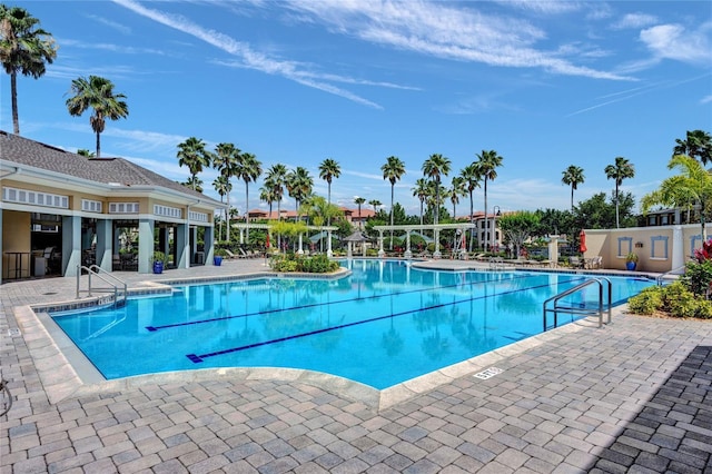 community pool featuring a patio area and fence