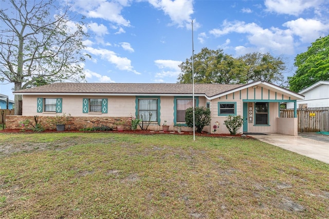 ranch-style house featuring board and batten siding, concrete driveway, a front lawn, and fence