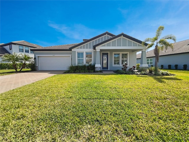 view of front facade featuring a garage, decorative driveway, board and batten siding, and a front lawn