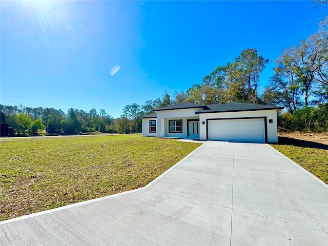 view of front of property featuring a front yard, concrete driveway, a garage, and stucco siding