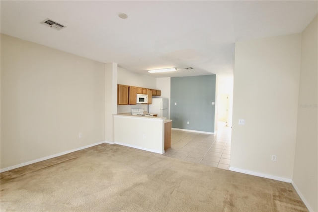 unfurnished living room featuring light carpet, light tile patterned floors, baseboards, and visible vents