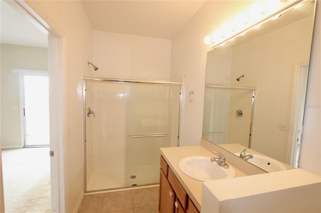 bathroom with tile patterned floors, a shower stall, and vanity