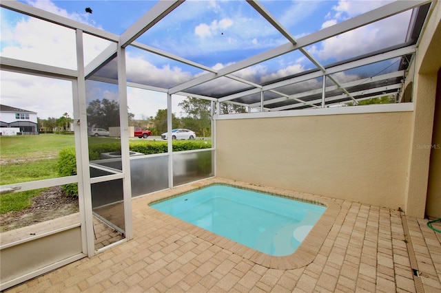 view of pool featuring a patio area and glass enclosure