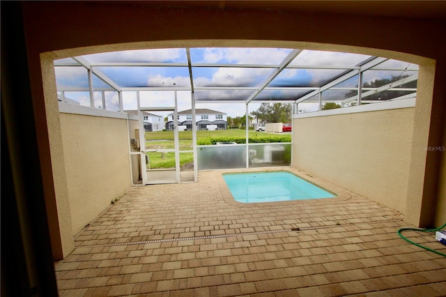 view of swimming pool featuring a lanai and a patio area