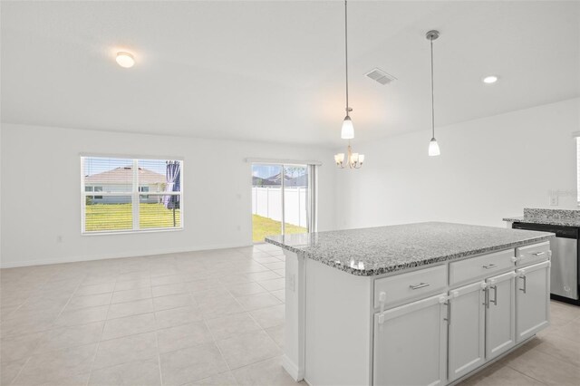 kitchen featuring visible vents, dishwasher, a kitchen island, open floor plan, and light stone countertops