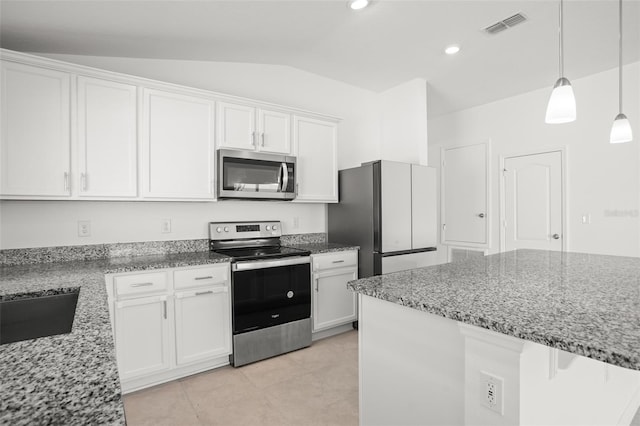 kitchen with stone counters, stainless steel appliances, white cabinets, vaulted ceiling, and pendant lighting