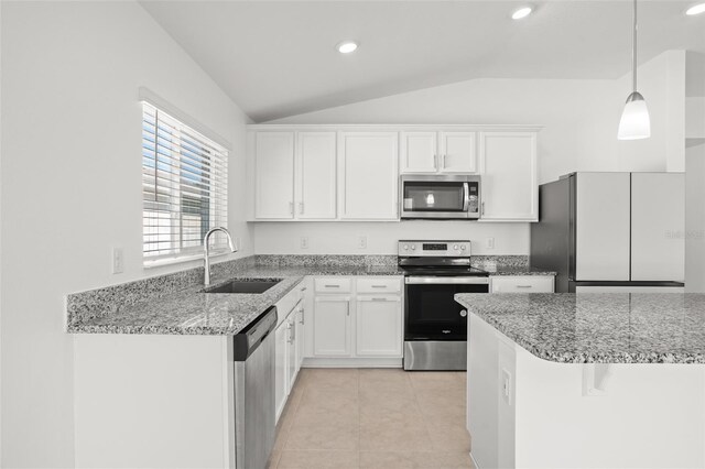 kitchen with appliances with stainless steel finishes, light tile patterned flooring, a sink, and white cabinets