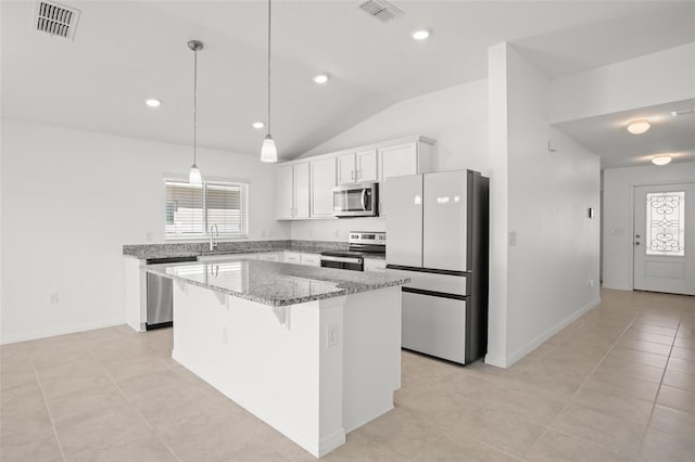 kitchen with visible vents, appliances with stainless steel finishes, a center island, a healthy amount of sunlight, and white cabinetry