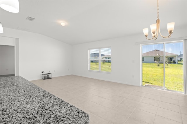 living area with lofted ceiling, visible vents, an inviting chandelier, light tile patterned flooring, and baseboards