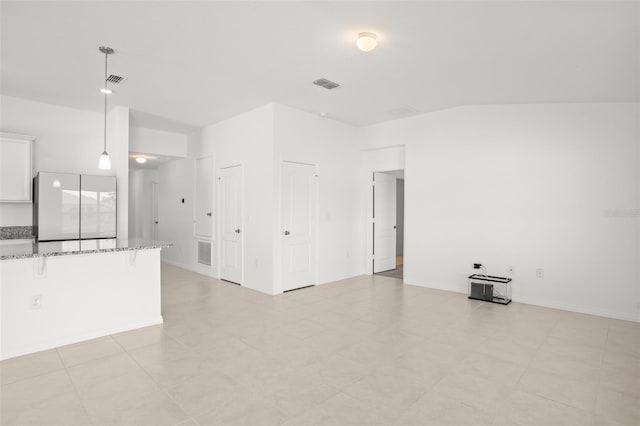 unfurnished living room with visible vents