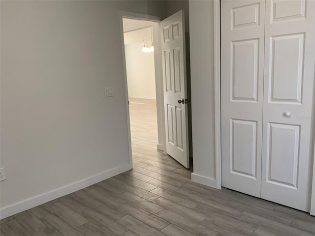 hall with wood finished floors and baseboards