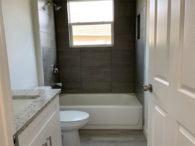 full bathroom with toilet, tub / shower combination, wood finished floors, and vanity