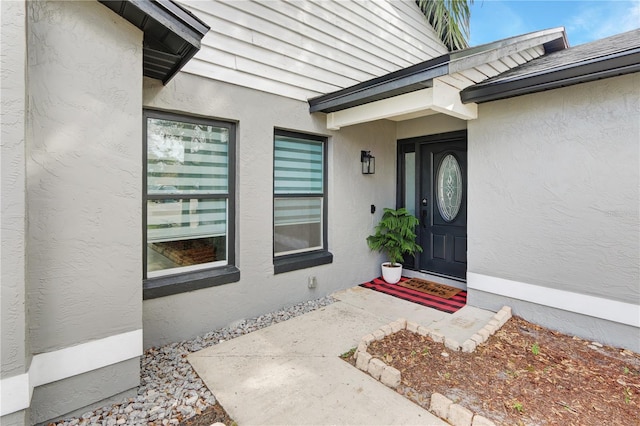 property entrance featuring stucco siding