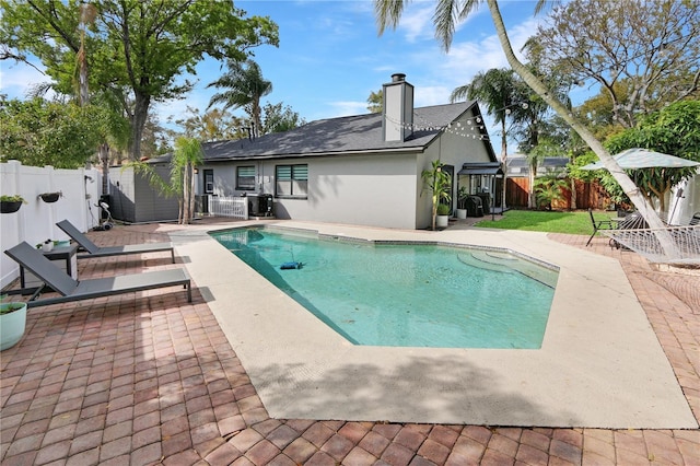 view of swimming pool with a patio area, a fenced in pool, and a fenced backyard