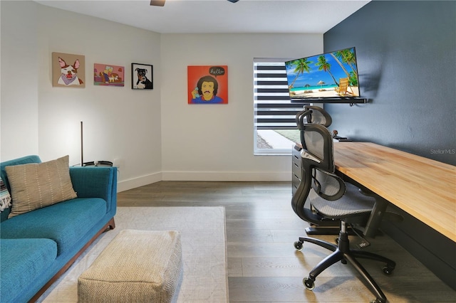 office area with ceiling fan, baseboards, and wood finished floors