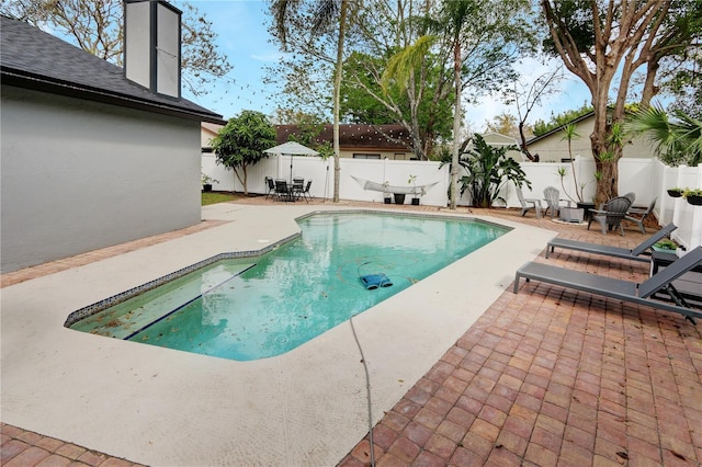 view of swimming pool with a fenced backyard, a fenced in pool, and a patio