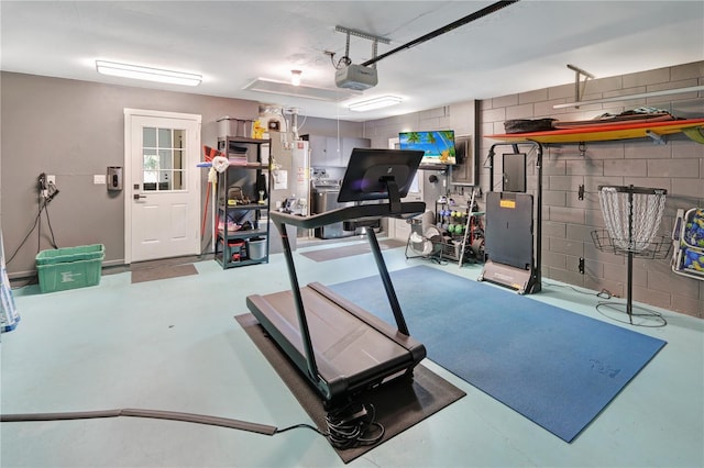 workout room with concrete block wall and a garage