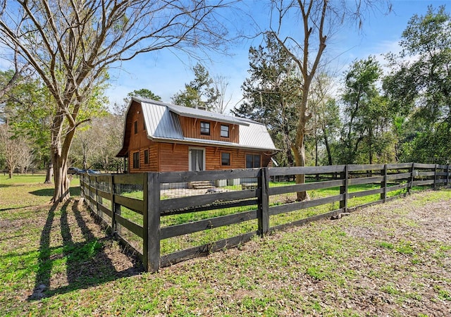 exterior space featuring a fenced front yard and metal roof