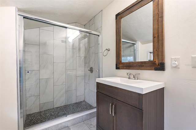 bathroom with a stall shower and vanity