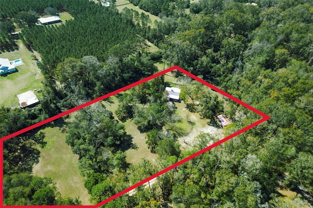 drone / aerial view featuring a forest view