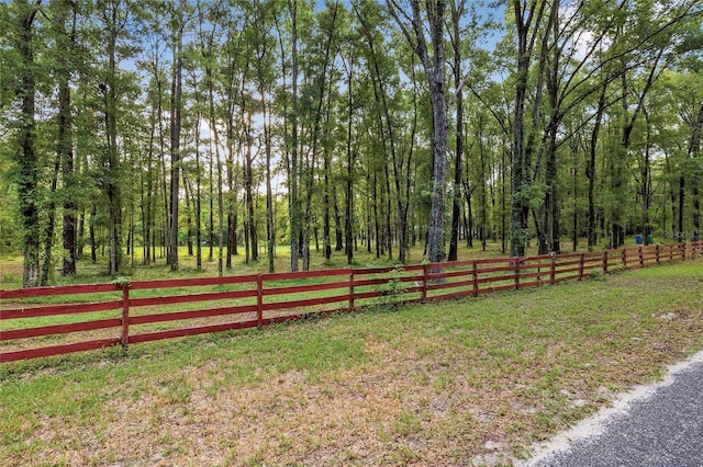 view of property's community with a yard and fence