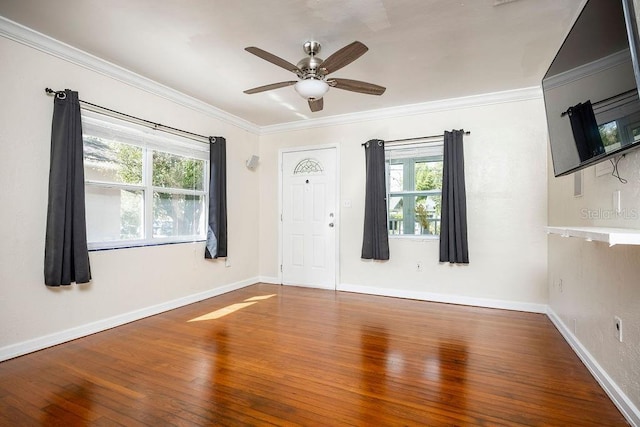 unfurnished room featuring ornamental molding, hardwood / wood-style flooring, and baseboards