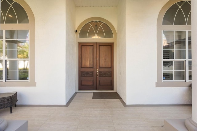 entrance to property with stucco siding