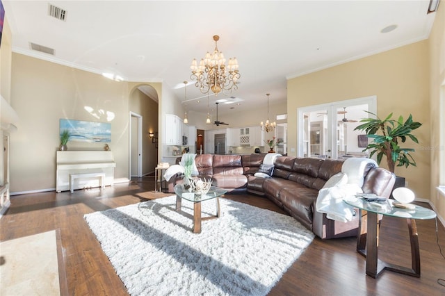 living area featuring dark wood-type flooring, visible vents, and ornamental molding