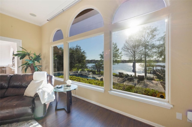 sunroom featuring a water view