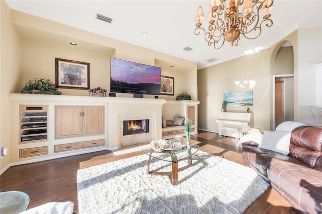 living area featuring a glass covered fireplace, wood finished floors, visible vents, and ornamental molding