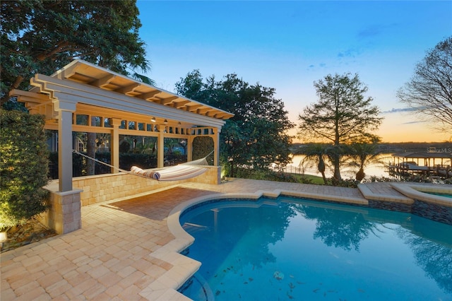 outdoor pool with a patio area and an in ground hot tub