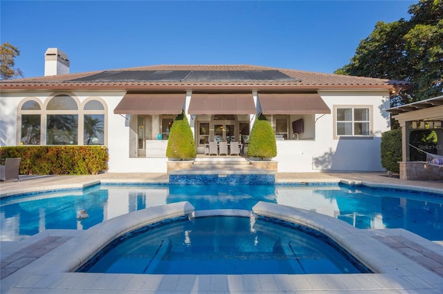 view of swimming pool featuring a patio area and a pool with connected hot tub